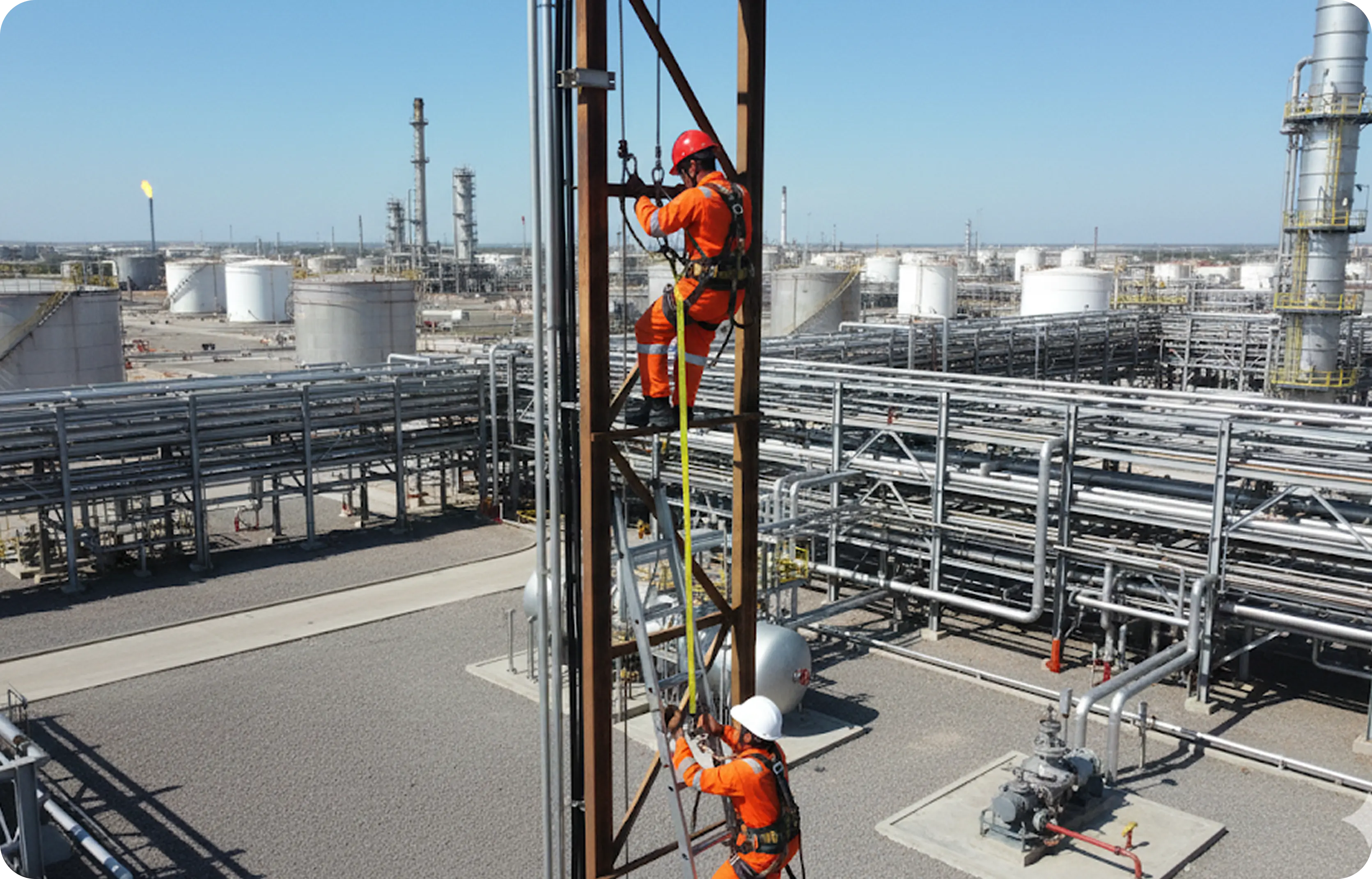 Workers on industrial platform with vertical lifeline